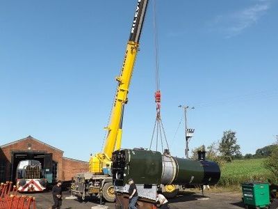 The boiler is lifted off the wagon and lowered to pick up the ashpan.